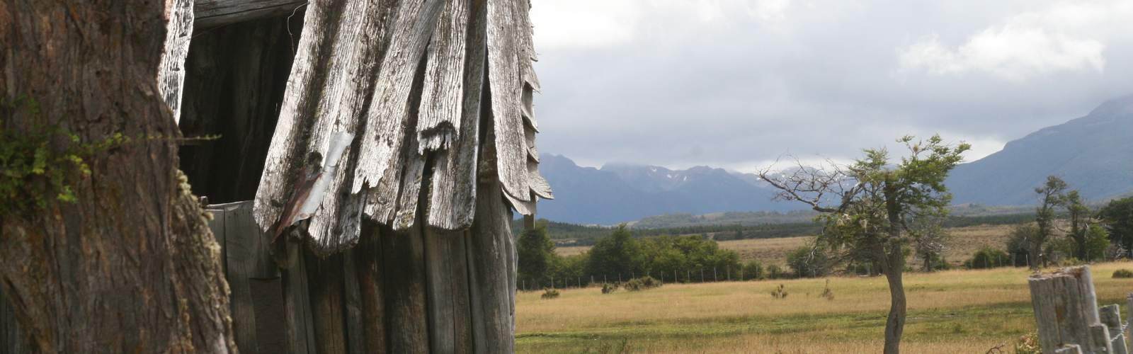 Old wooden shed and mountains on a Patagonian estancia