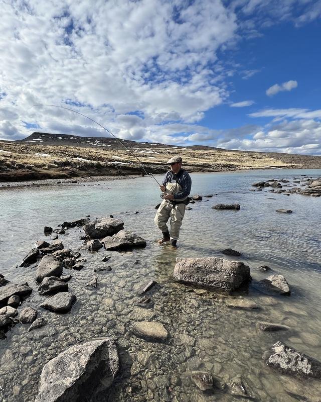An angler wading a clear Patagonian river